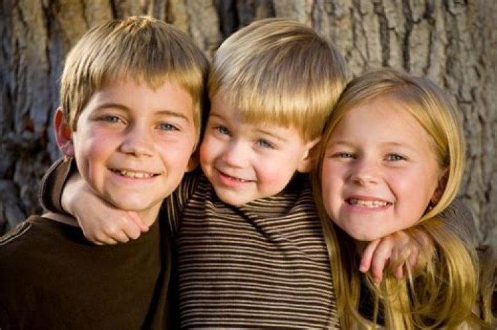 Who are his 2 half brothers and half-sister? |